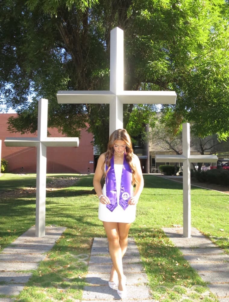 Faith standing before crosses